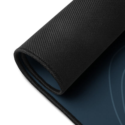 Digital mockup of the Sarnaya Contour Desk Mat with one corner rolled back, revealing the black textured underside and navy printed top.